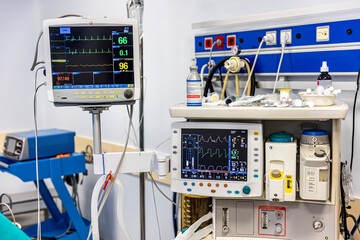 hospital monitor displaying vital signs: heart rate, blood pressure, temperature, and pulse...