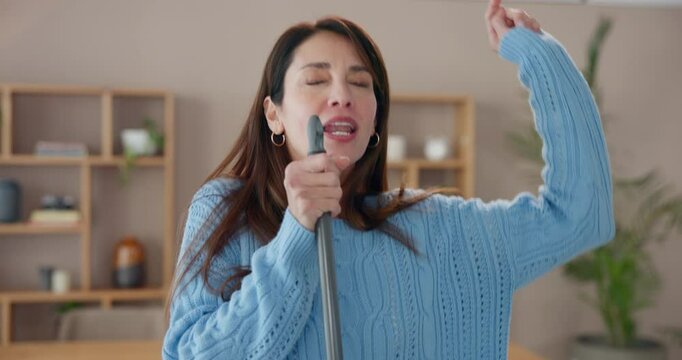 Woman, singing or sweeping to clean home with broom for wellness, joy or hygiene in living room. Dance, radio song or funny cleaner with spring cleaning music for working to stop dust, dirt or germs