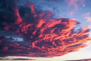 Fototapeta premium Dramatic sunset sky with red, orange, and purple clouds, striking contrast