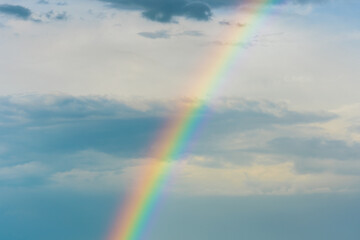 Colorful rainbow in the evening sky after rain