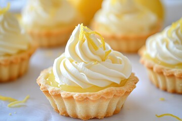 Small tartlets filled with tangy lemon curd, topped with a swirl of whipped cream and a lemon zest garnish