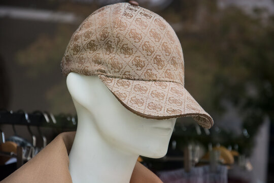 Mulhouse - France - 8 September 2024 - Closeup of beige Gucci baseball cap on mannequin in a fashion store showroom