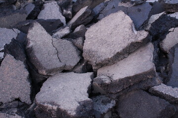 Close-up chunks of asphalt. Destroyed asphalt close-up. Road works