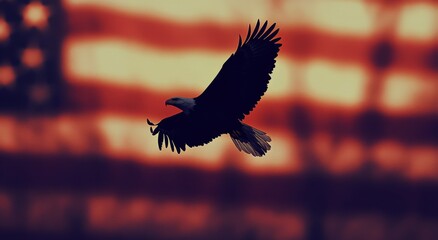 Fototapeta premium Majestic bald eagle soaring against a blurred American flag backdrop in a patriotic display