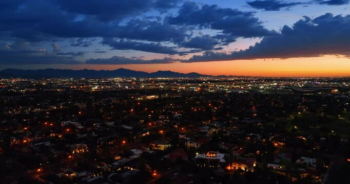 Cozy city panorama with soft lights on in the evening. Drone footage above Phoenix, Arizona, the USA at twilight.