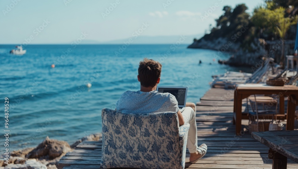 Poster a man sitting on an armchair at the end of a wooden pier, working on a laptop with a view of the sea