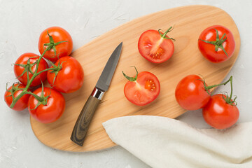Fresh tomatoes on concrete background, top view