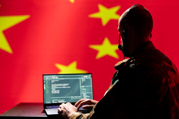 Chinese army telecommunication systems operator using radio and satellite tech, talking in...
