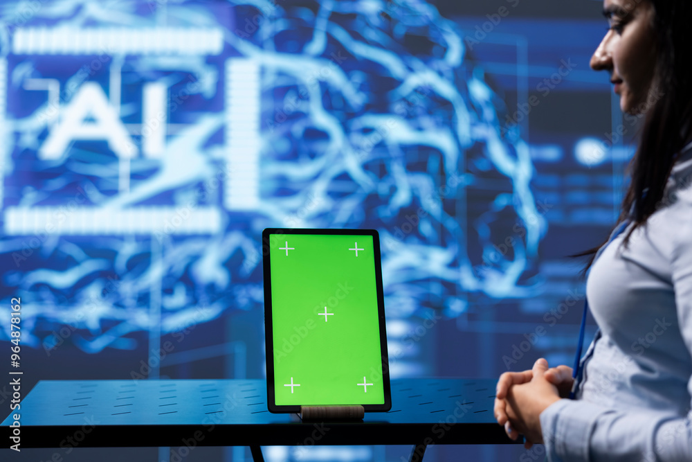 Poster engineer uses ai machine learning to extract information from complex data on green screen tablet. w