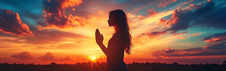 Silhouette of a Girl Praying at Sunset