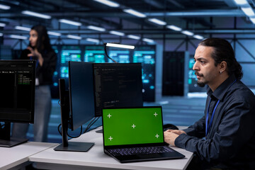 Admin using isolated screen notebook to oversee servers used for managing databases, hosting...