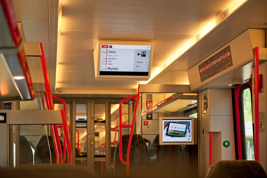 VOSS, NORWAY - JULY 16, 2018: Passenger information system displays a status of the train trip and the list of stations between Voss - Myrdal