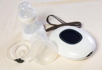 Closeup shot of mini electric breast pump lying on cloth