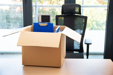 Moving office and packing belongings in a box or getting fired