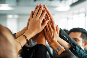 Many happy business people raise hands together with joy and success. Company employee celebrate...