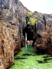 Green sea view onlooking a cave