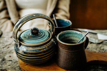 Ceramic Teapot and Cups with Rustic Design in a Café Setting
