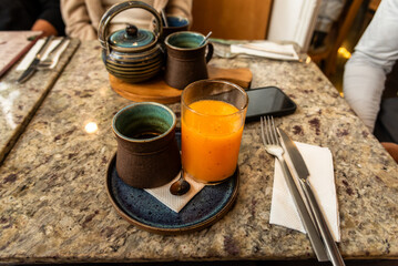 Fresh Papaya Juice with Ceramic Cups in a Cozy Café Setting