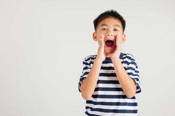 Asian happy portrait cute young kid boy standing hand on mouth talking news announcement studio shot isolated on white background, Thai primary child announcement