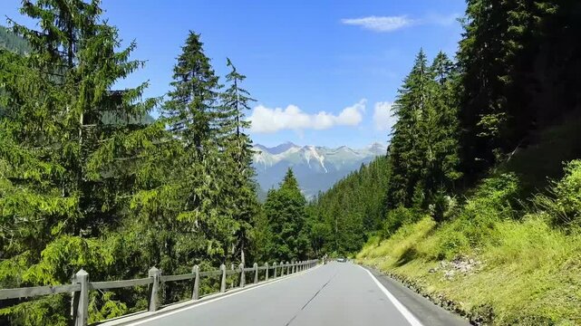 Mountain Road with Bicycle and Car in a Sunny Summer Day in Albula Pass, Grisons, Switzerland, Europe