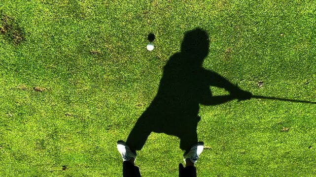 Golfer with Her Shadow Teeing Off with His Golf Club Driver on the Tee Box on Golf Course a Sunny Summer Day in Switzerland. (Slow Motion)