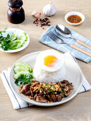 Rice topped with pork, garlic, pepper and fried egg