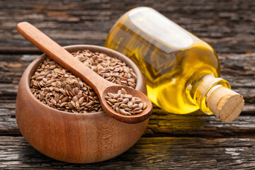 Organic flax seeds and oil in the glass bottle - Linum usitatissimum.
