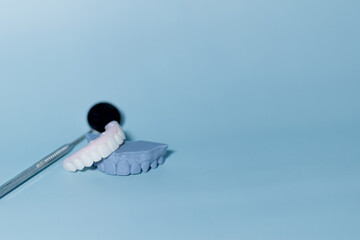 Denture and Tools on Blue Background, Implant-supported hybrid prosthesis