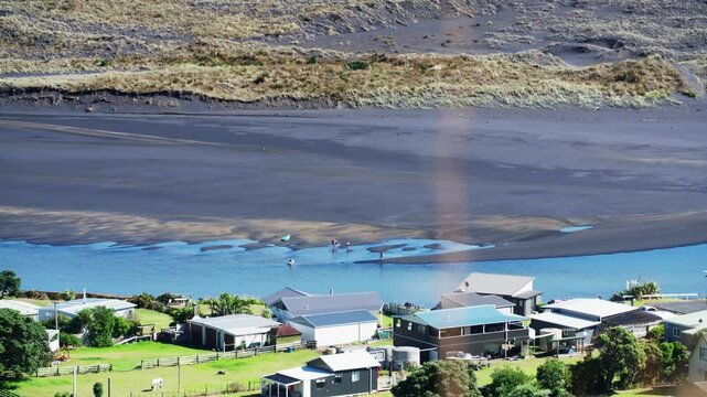 Coastline, estuary and farmland and rural town of Marokopa, Waikato, New Zealand.
