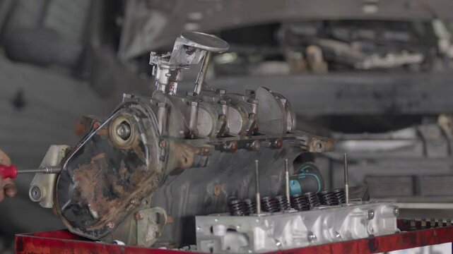 Repairing an Old Tech Car Engine on a Workshop Table Footage.