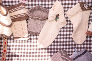 Handmade woolen socks, knitted warm clothing, cozy winter accessories displayed on checkered fabric, holiday gift idea, festive season concept