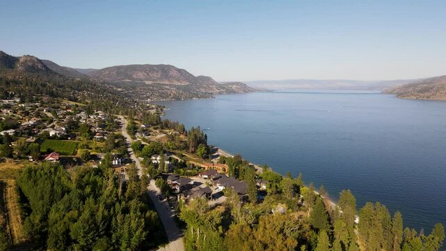 aerial video over Okanagan Lake from Peachland flying towards Kelowna, BC Canada travel and tourism
