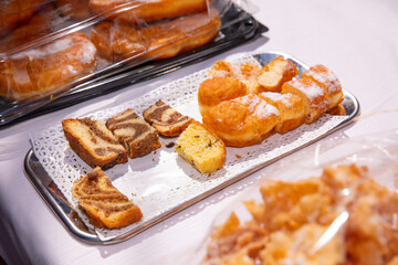 Assorted pastries, cakes on a tray at bakery event, colorful baked goods concept