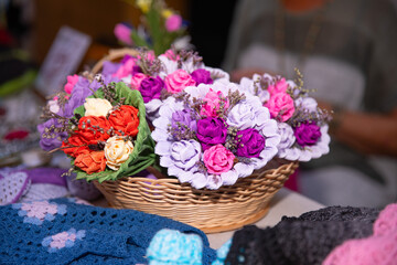 Colorful, handmade, floral bouquets in wicker basket, vibrant silk flowers, market setting, handmade crafts and decorations concept
