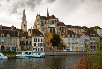 Fototapeta premium Image of view with river of famous old town Auxerre at cloudy day in France