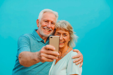 Head shot portrait happy senior couple taking selfie, having fun with phone cam, smiling aged wife and husband hugging, looking at camera, posing for photo, aged man vlogger recording video