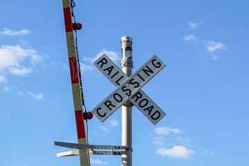 Railway crossing sign with blue sky