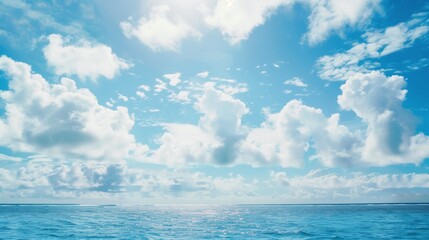 Obraz premium Serene Ocean Horizon Under a Blue Sky with Fluffy Clouds - Perfect for Nature and Travel Themes