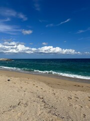 Tranquil Beach Scene with Clear Blue Skies and Rolling Waves