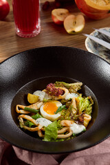 Delicious Calamari Salad with Potatoes and Egg in Elegant Black Bowl