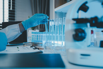 a researcher is conducting scientific experiments on a liquid substance, a scientist is using laboratory equipment to analyze a liquid sample, chemicals are tested in a lab