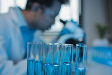 a scientist uses a microscope to look for contaminants in a test sample, a researcher uses a microscope to look closely at foreign objects, microscopes are being used in the laboratory