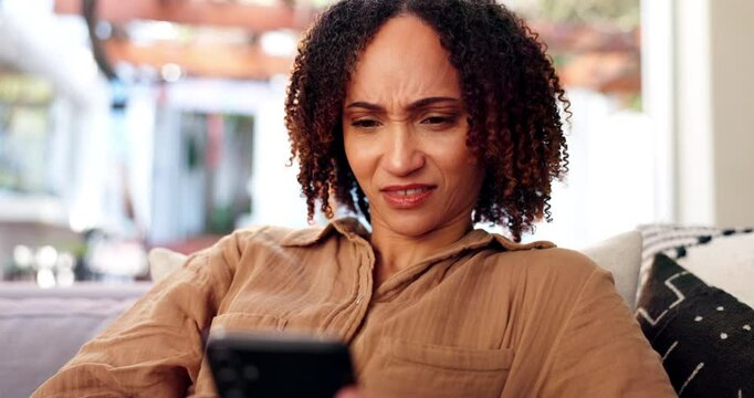 Home, woman and annoyed on smartphone for social media, text message and notification for reading. Sofa, female person and cellphone with mobile app for chat, online conflict and confused by contact