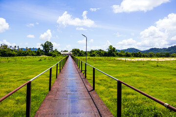 Fototapeta premium Boon Soong Iron Bridge with green glass field in Phang-nga Thailand in summer