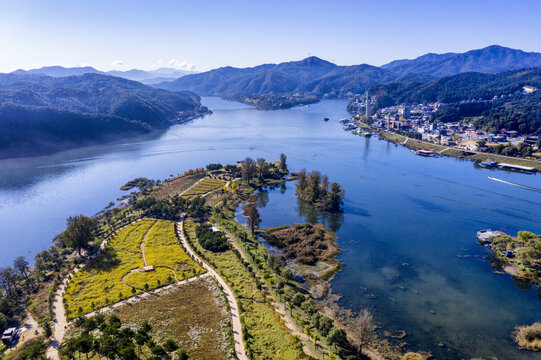 Gapyeong-gun, Gyeonggi-do, South Korea - October 19, 2019: Aerial and morning view of Jarasum Island on Bukhan River with the background of Nami Island