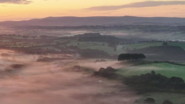 Aerial clip of Cookworthy Knapp and countryside on a misty morning, Devon, England, United Kingdom, Europe