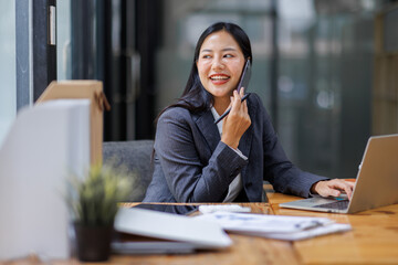 Modern Asian business woman in workplace office, doing planning analyzing the financial report, business plan investment, finance analysis concept