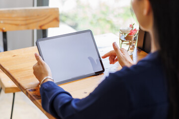Business asian woman freelancer using tablet with blank screen for design mockup device Tablet with blank screen for design mockup
