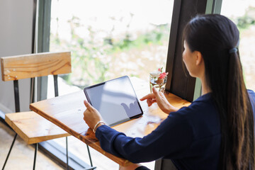 Business asian woman freelancer using tablet with blank screen for design mockup device Tablet with blank screen for design mockup

