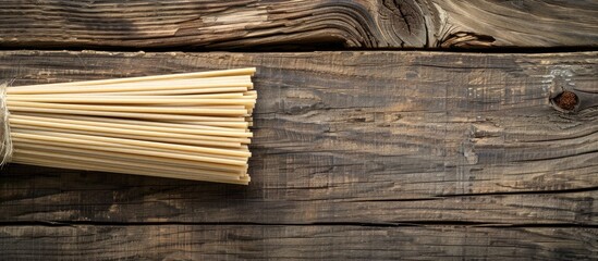 Fototapeta premium Dried Raw Soba Noodle Stick Over Wooden Background
